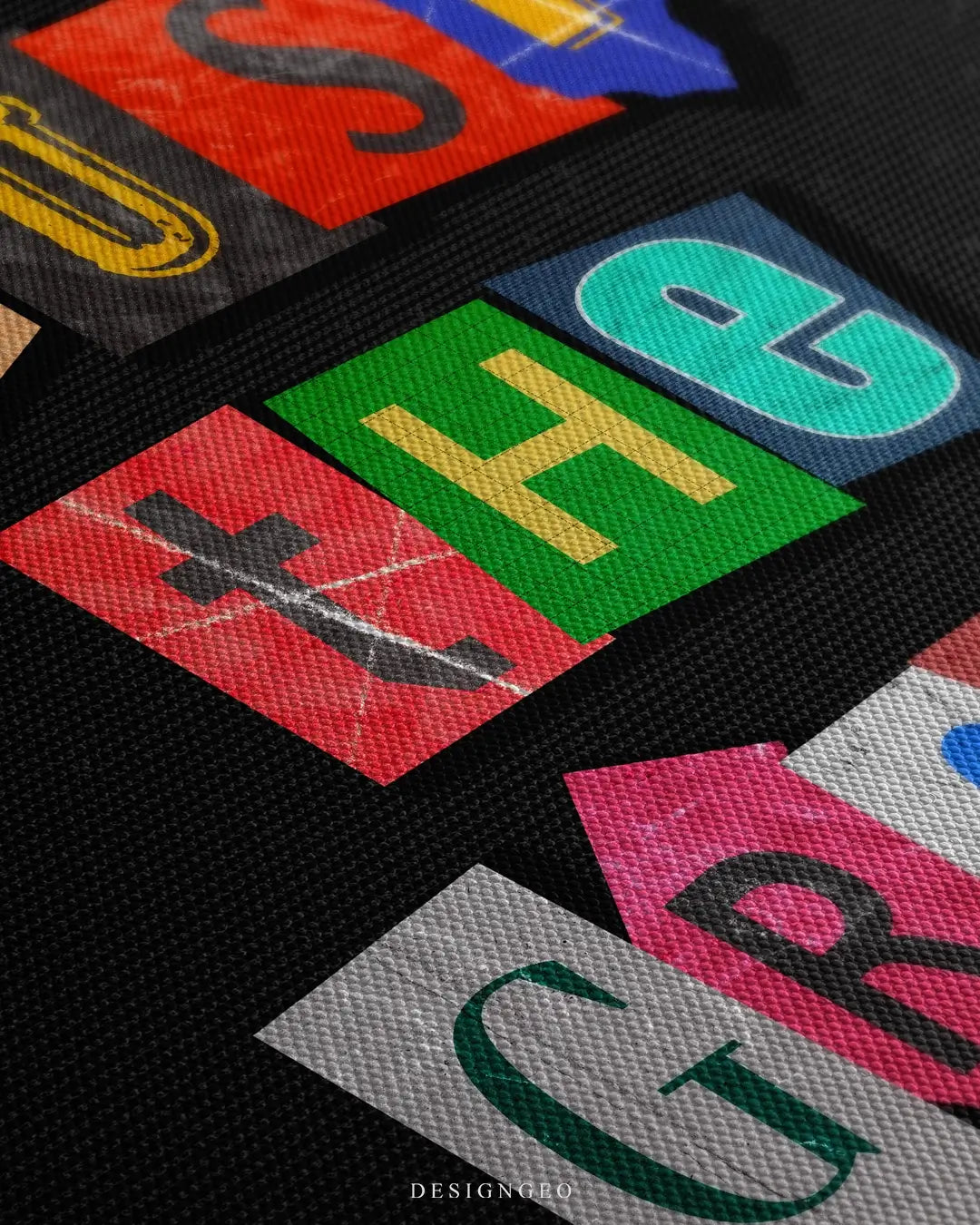 Close-up of motivational wall art featuring the phrase "Trust the Grind" in vibrant colorful typography with detailed paint stroke textures on a solid black background