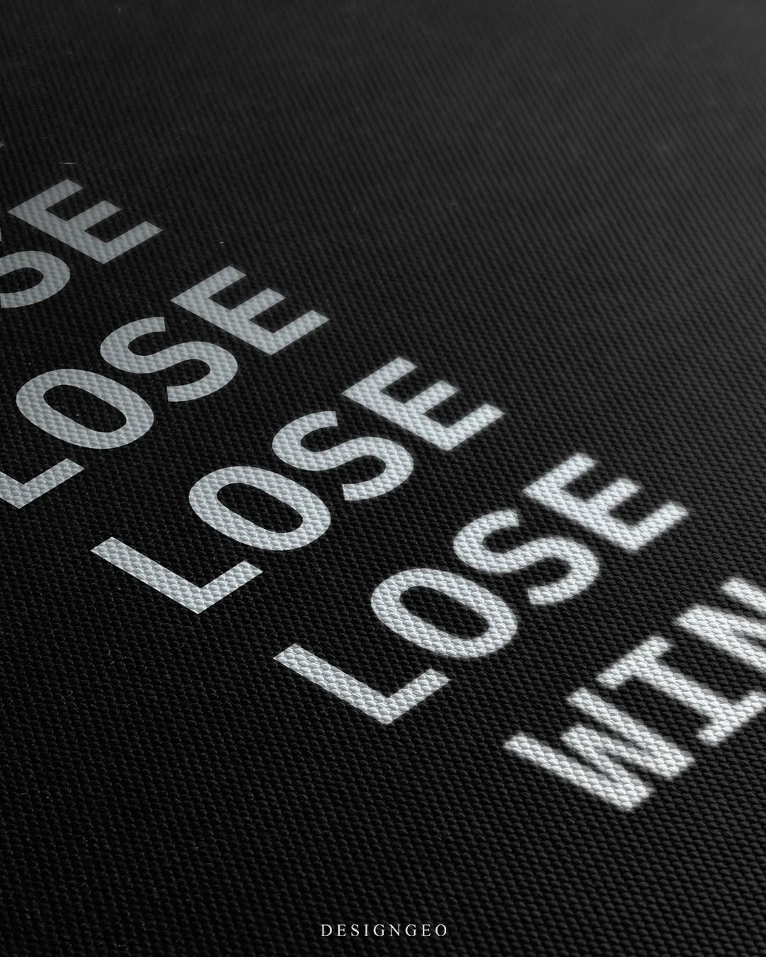 Angled macro view detailing woven canvas material texture, precise printed white typography of the phrase LOSE WIN, and subtle matte finish