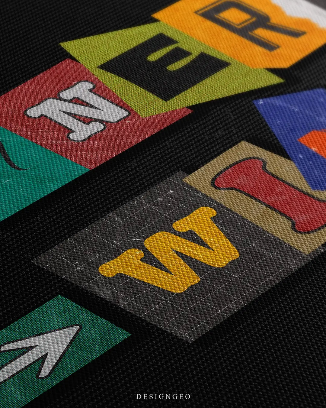Close-up of modern motivational wall art featuring the phrase Winners Win in bold, multicolored letters on a solid black background
