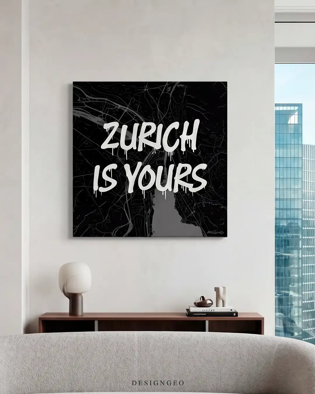 Modern minimalist living room interior featuring the black and white Zurich city map canvas print mounted on a beige wall above a dark wood credenza next to a large window