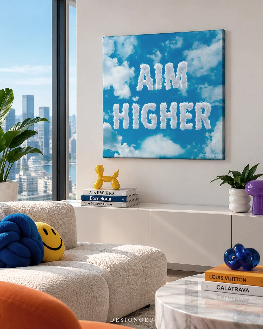 Square blue sky canvas print with cloud letters spelling AIM HIGHER mounted on a white wall in a modern high-rise apartment with floor-to-ceiling city view windows