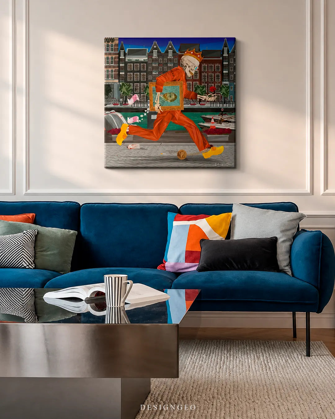 Square Amsterdam skeleton canvas print displayed on a white wall above a modern blue velvet sofa with colorful pillows in a contemporary living room setting