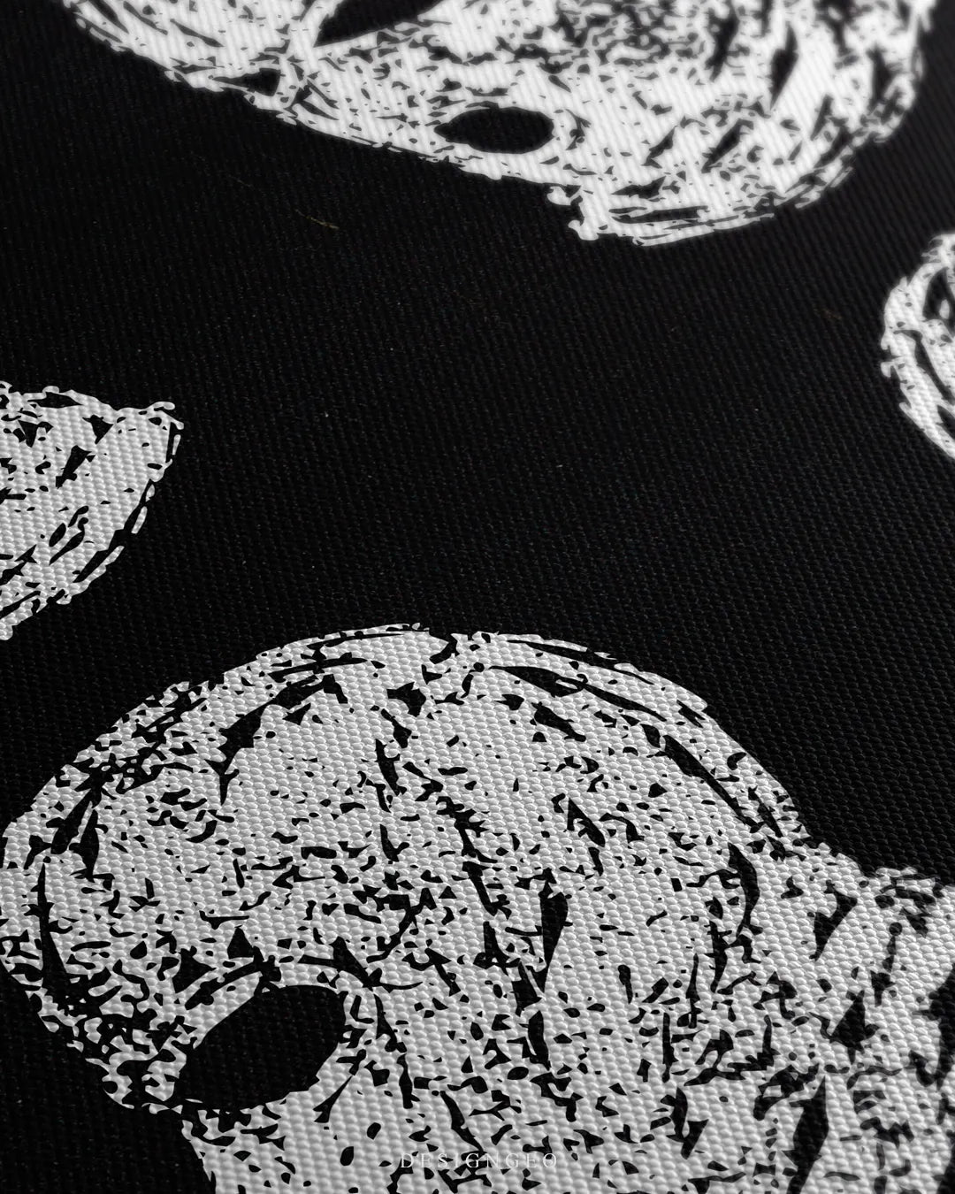 Straight-on close-up shot highlighting the four white balaclavas shown from front, profile, and three-quarter angles with textured screen print details
