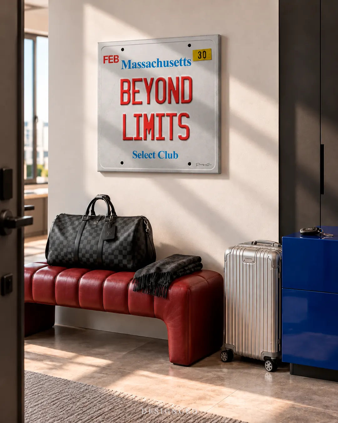 Modern entryway hall featuring a square canvas print of a Massachusetts license plate with BEYOND LIMITS text mounted above a red leather bench and travel luggage