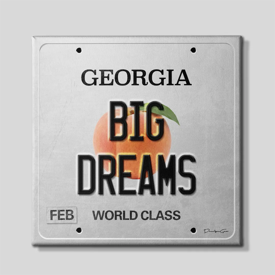 Front view of a square motivational canvas print designed as a vintage silver Georgia license plate featuring bold black BIG DREAMS lettering, central peach graphic, and WORLD CLASS slogan