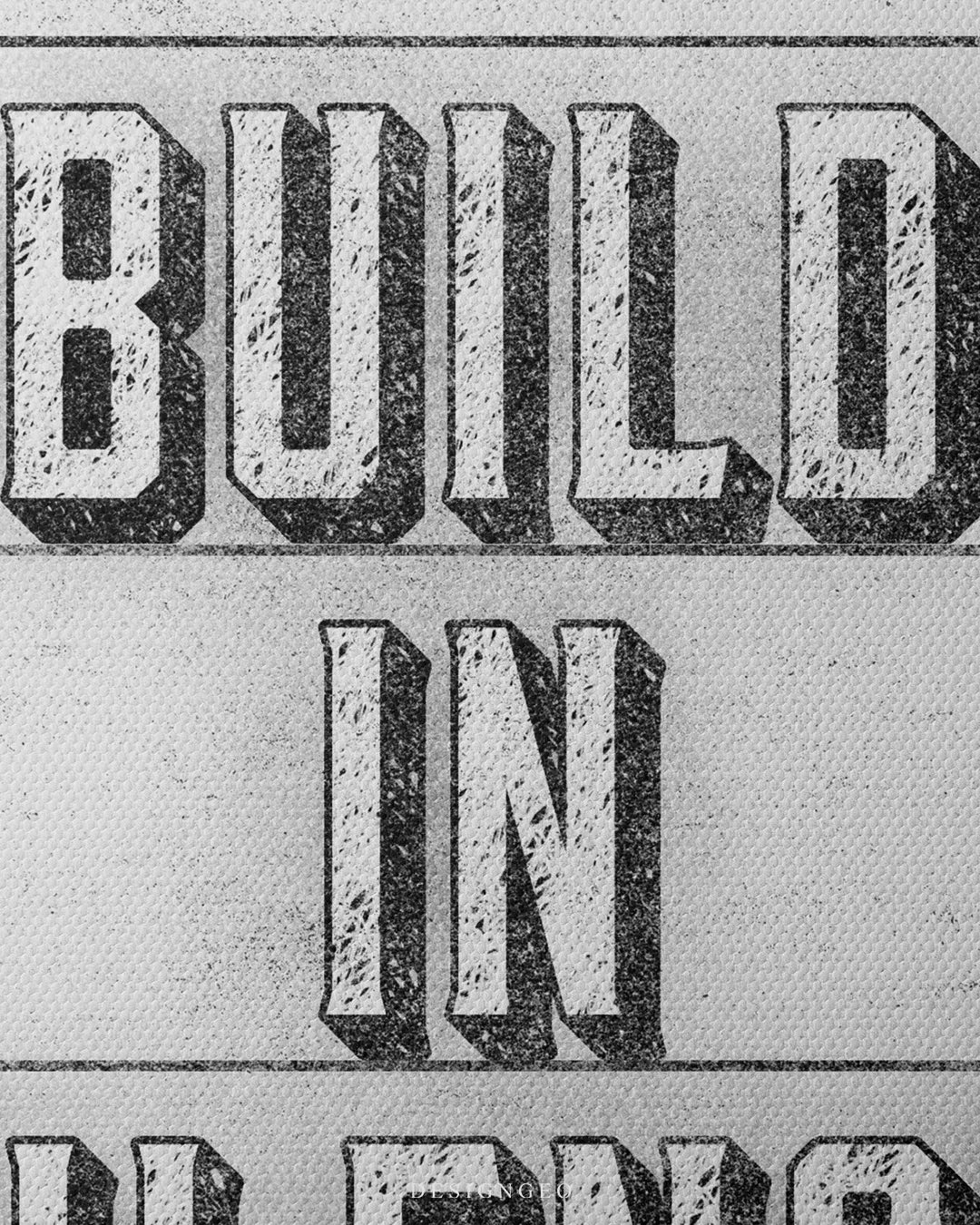 Medium shot showing 3D drop-shadow lettering for the phrase BUILD IN SILENCE printed on a vintage light gray textured canvas