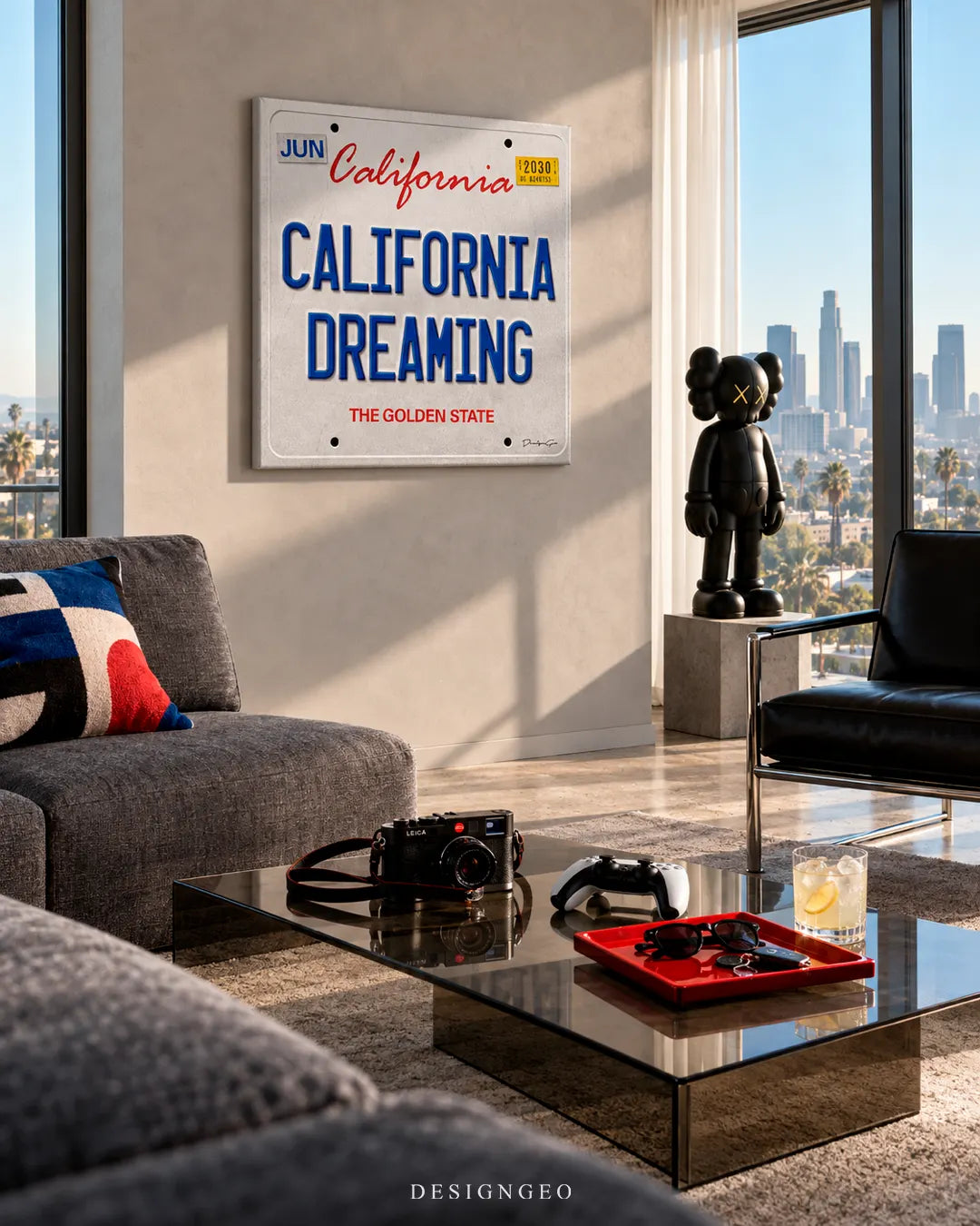 High-rise luxury living room with skyline views featuring a square California license plate canvas print with CALIFORNIA DREAMING typography mounted on a light wall