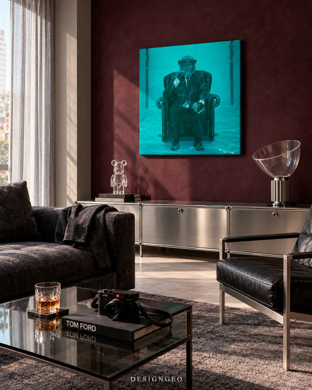 Modern luxury living room featuring a square underwater chimpanzee canvas print mounted on a dark burgundy accent wall above a metallic USM Haller sideboard