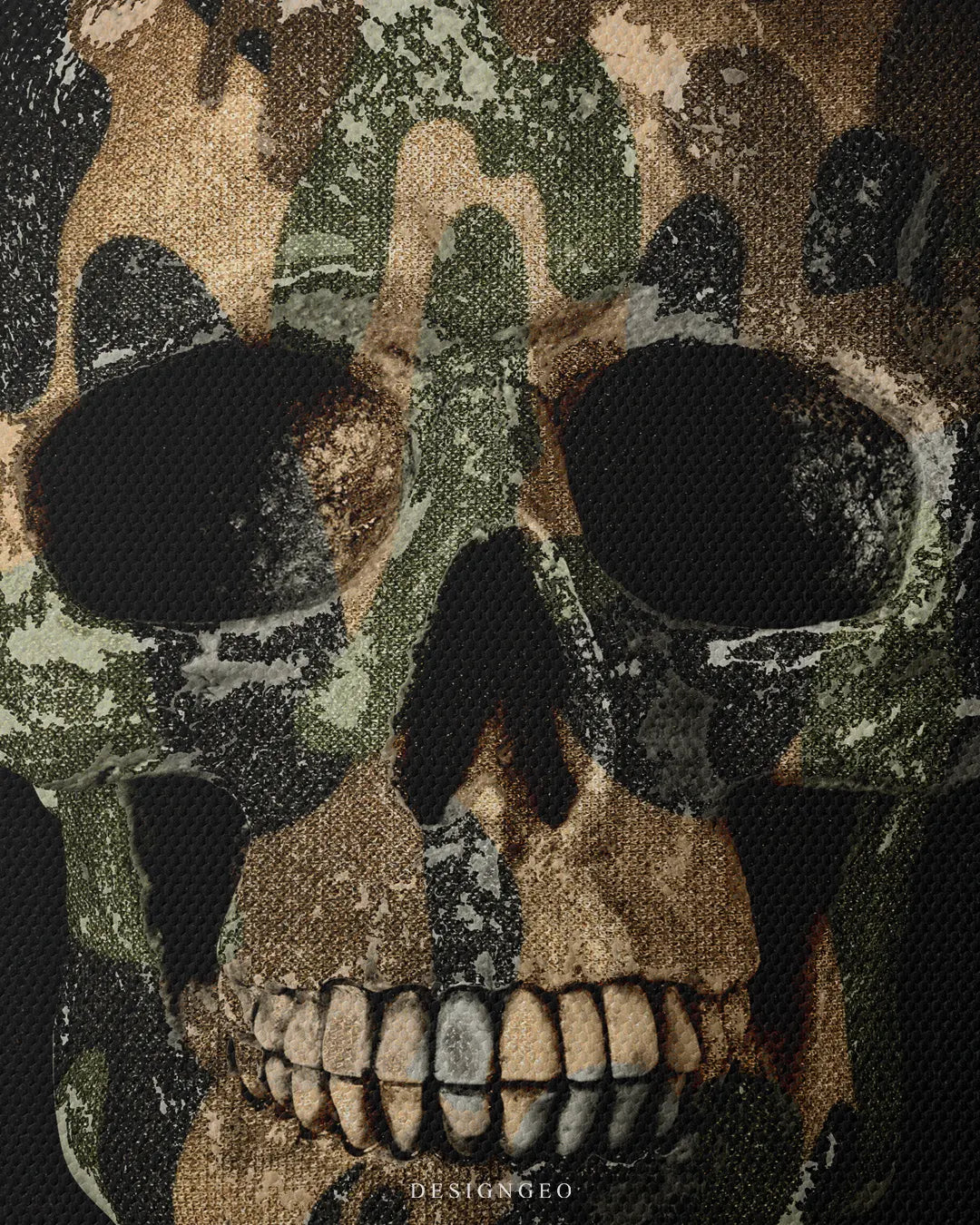 Close-up macro detail shot showing fine canvas texture, weathered military camouflage paint layer, dark eye sockets, and detailed skull teeth