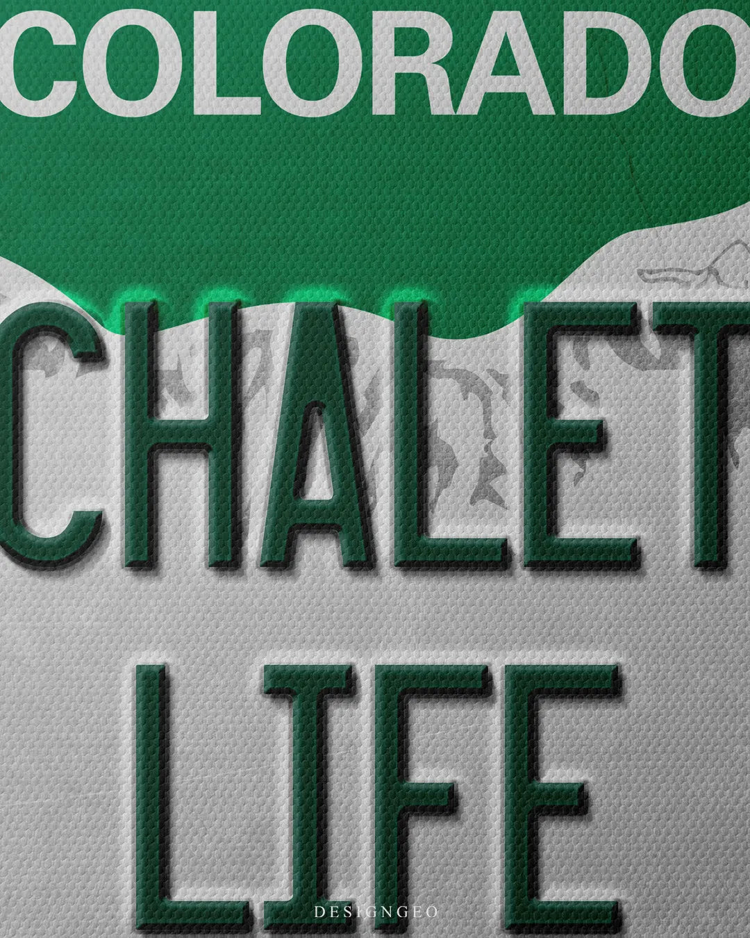 Medium shot showing dark green embossed CHALET LIFE typography below a white Colorado header on a green mountain silhouette and gray background
