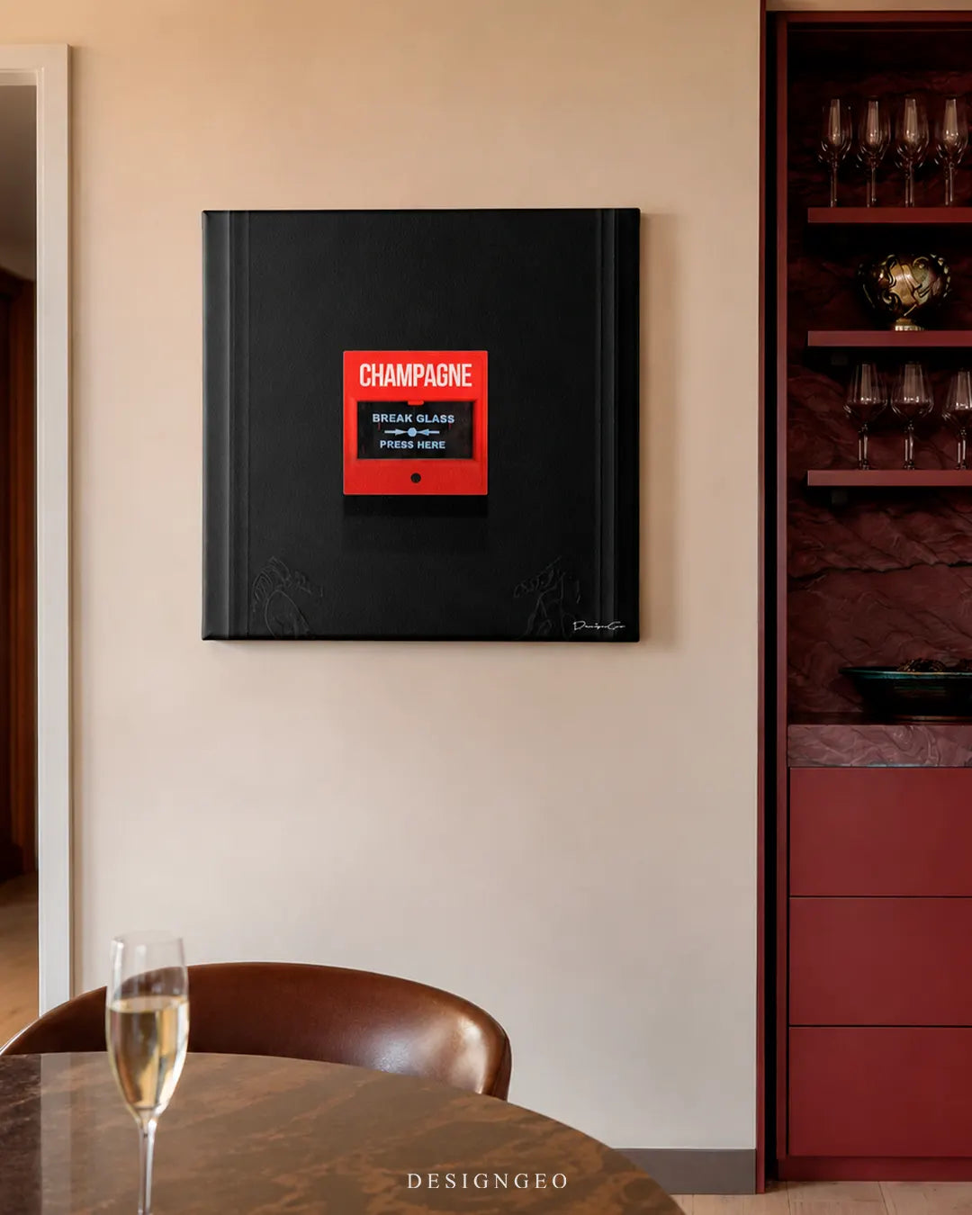 Square red Champagne emergency button canvas wall art mounted on a beige wall next to a luxury wine display cabinet and a marble table with a glass of champagne