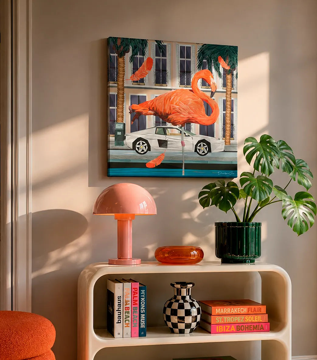 Modern canvas wall art featuring a pink flamingo next to a white sports car, displayed above a chic console table