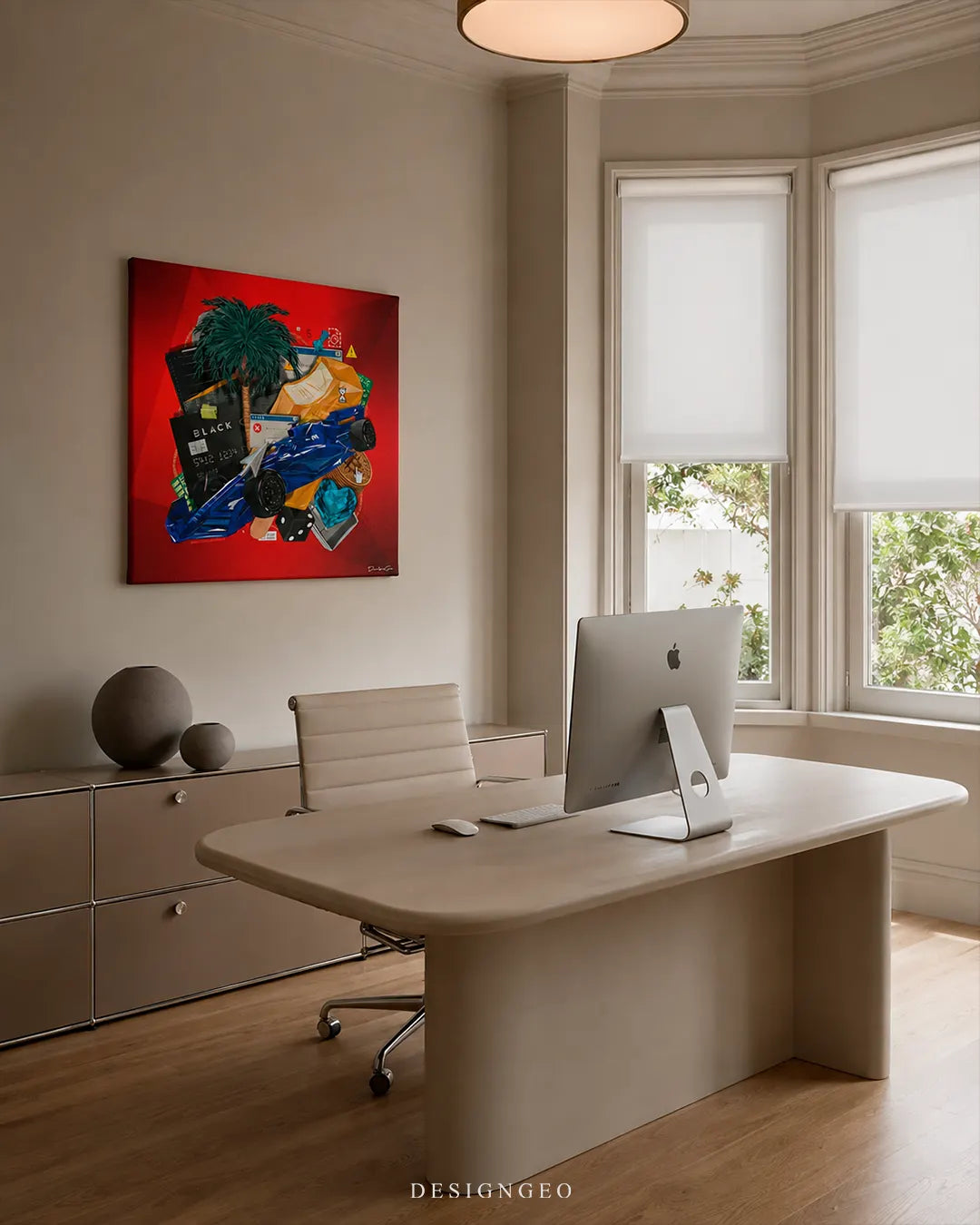 Square digital assets red canvas wall art mounted on a beige wall in a modern luxury office above a beige desk with a desktop computer