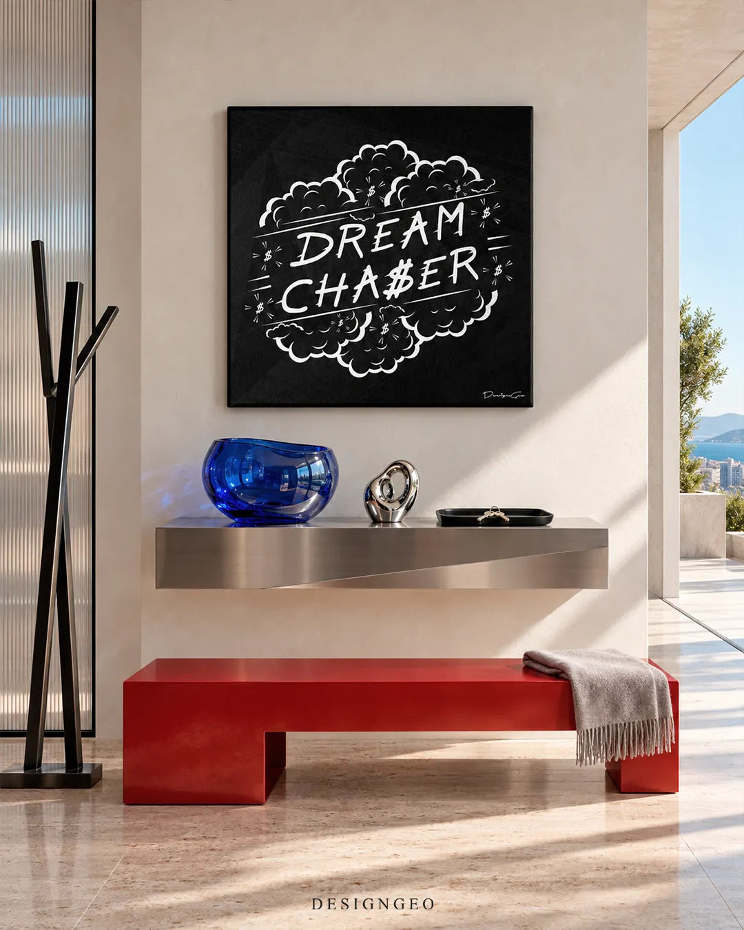 Square black canvas print featuring white DREAM CHASER typography inside a comic cloud outline mounted on a beige wall in a modern entryway above a red bench