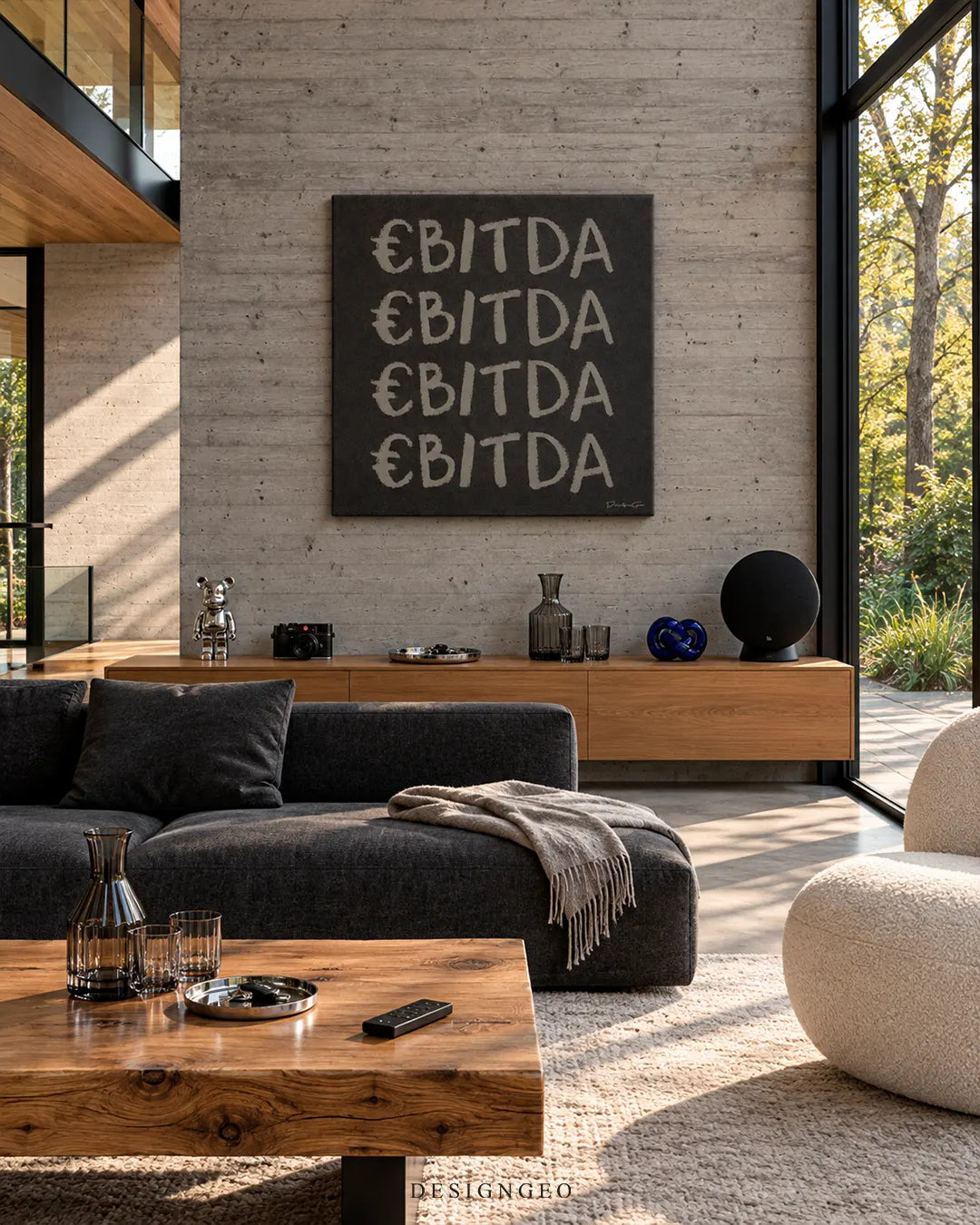 Square black canvas print featuring repeated grey EBITDA typography with euro sign mounted on a concrete wall in a modern living room above a wooden credenza and charcoal sofa