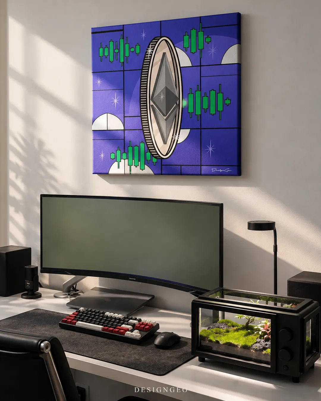 Square blue canvas print featuring a silver Ethereum coin surrounded by green trading candlestick charts mounted on a beige wall above a curved monitor workstation