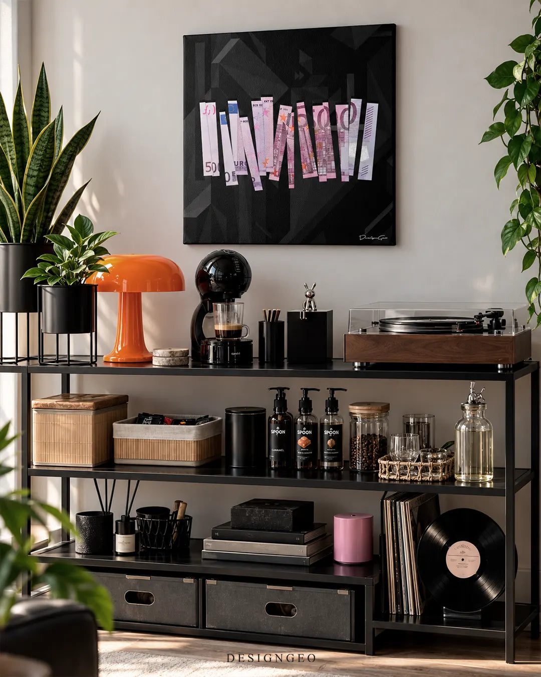 Square black canvas print featuring a shredded 500 Euro banknote mounted on a white wall above a black metal shelving unit styled as a coffee and record station