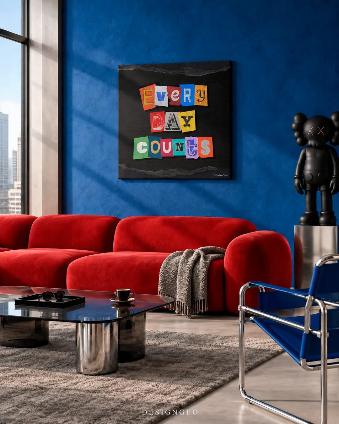 Modern living room decor featuring a square canvas print with colorful magazine cutout letters spelling EVERY DAY COUNTS mounted on a deep blue accent wall above a red sofa