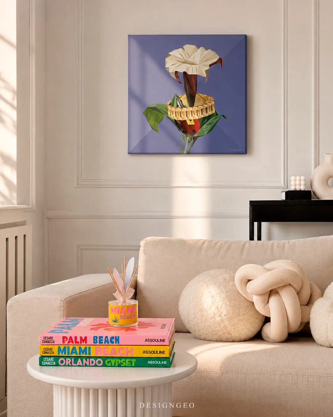 Square Floral Awakening canvas print mounted on a classic wainscoted white wall above a beige sofa with Assouline travel books on a side table