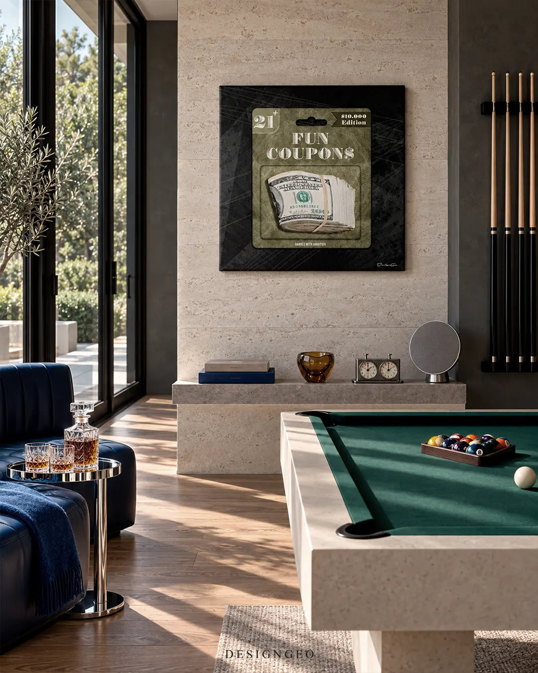 Square dark canvas print featuring toy-packaged US dollar bills with FUN COUPONS typography mounted on a beige stone wall in a luxury game room above a pool table and blue sofa