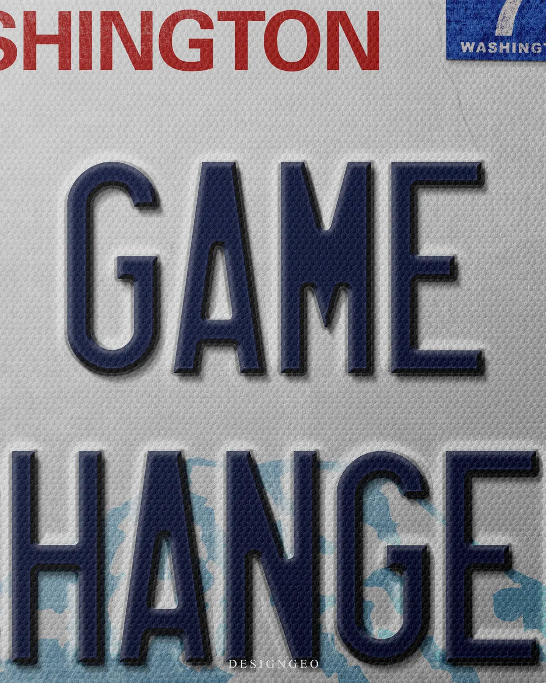 Close-up shot showing dark blue embossed GAME CHANGER typography over a light blue mountain landscape graphic and red WASHINGTON title with registration stickers