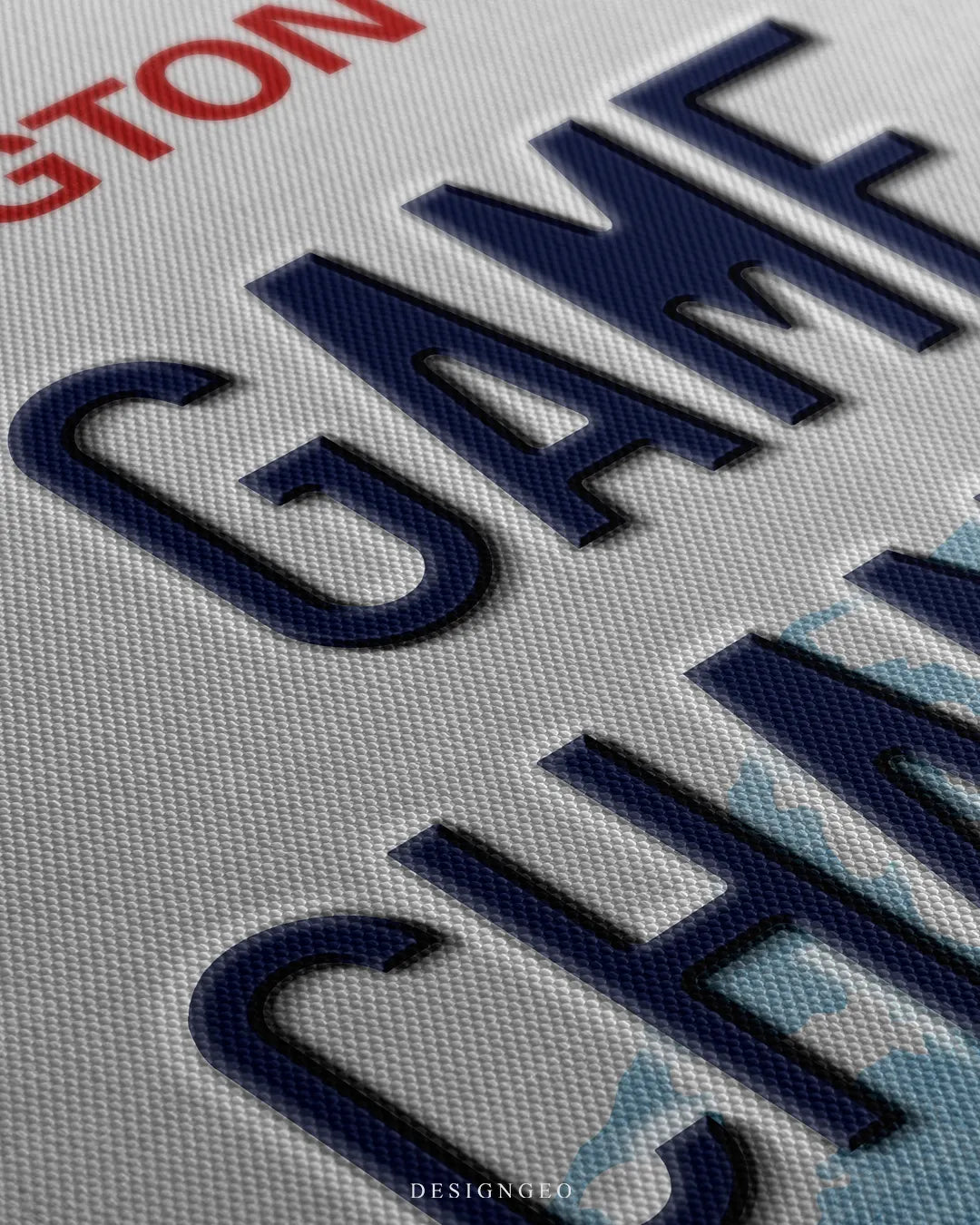 Angled close-up detail shot highlighting the 3D dark blue embossed GAME CHANGER letters, subtle drop shadows, and fine woven canvas fabric texture