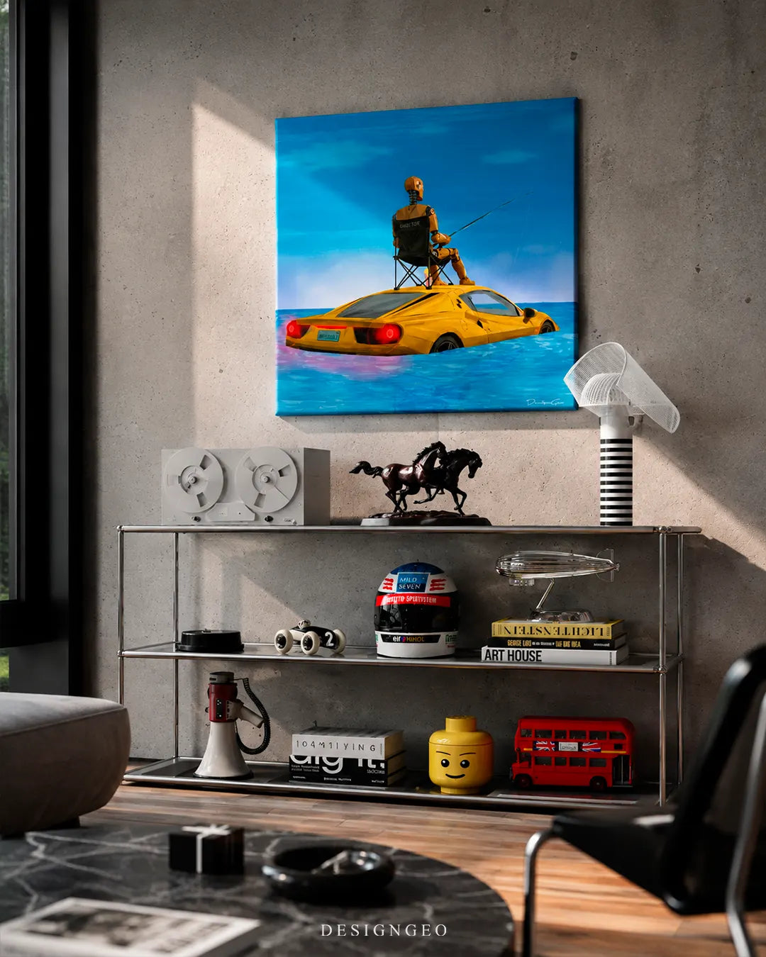 Square surreal crash test dummy canvas print mounted on a concrete wall above a metallic industrial shelving unit with a racing helmet, Lego head, art books, and vintage audio gear