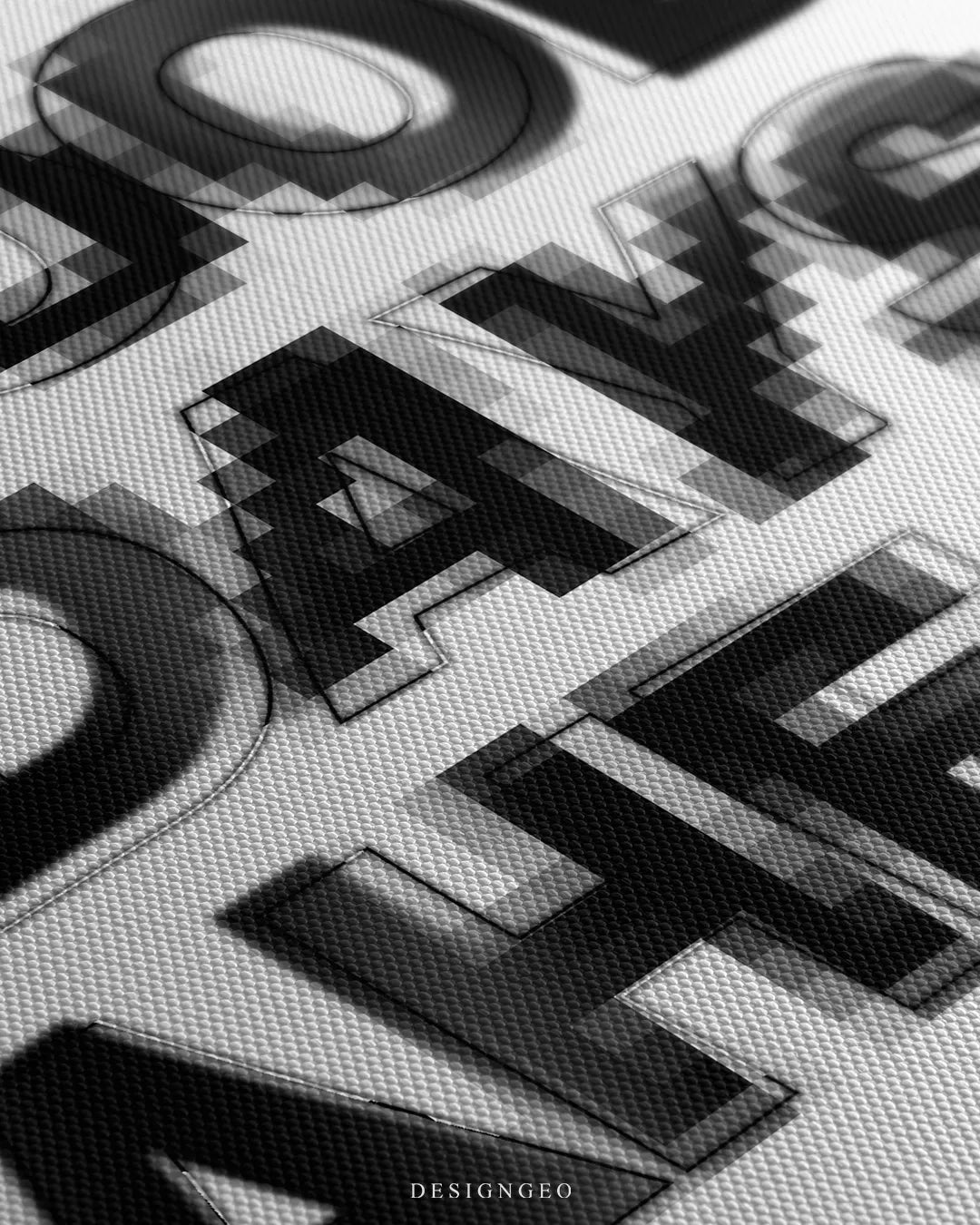 Angled macro view detailing fine woven canvas fabric texture, crisp geometric font edges, and subtle pixelated blur shading on the black and white motivational art
