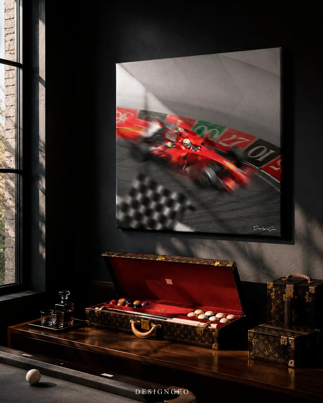 Square red racing car canvas print mounted on a dark wall above a luxury wooden billiard table, open monogram pool cue case, whiskey glasses, and leather trunks