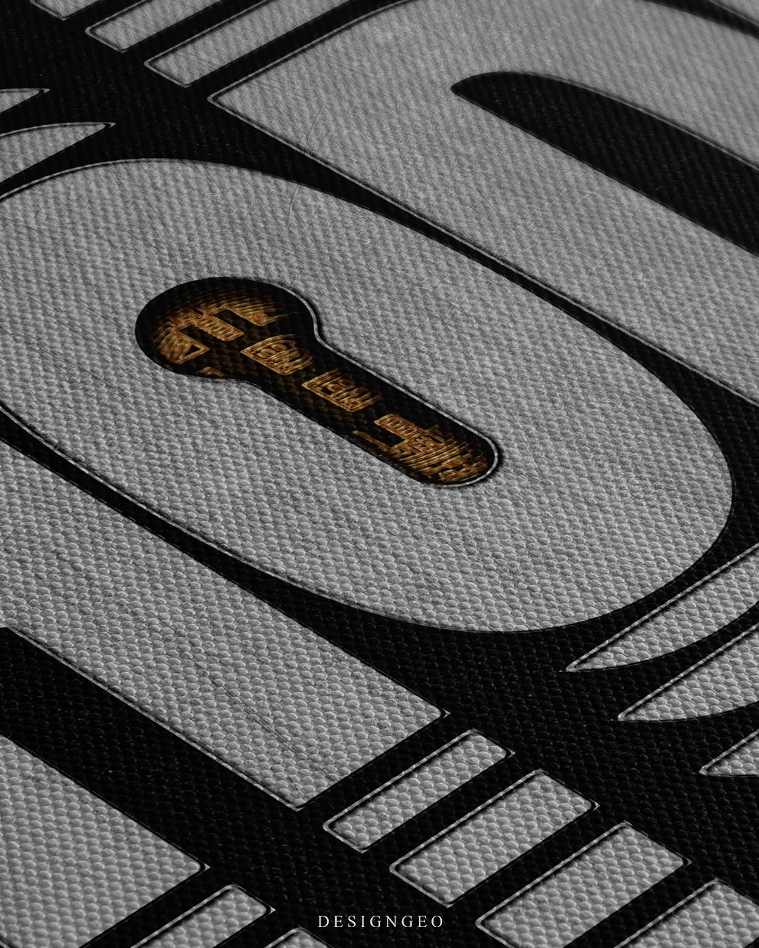 Extreme macro detail shot highlighting the fine woven canvas texture and a golden Bitcoin keyhole cutout inside the silver letter O