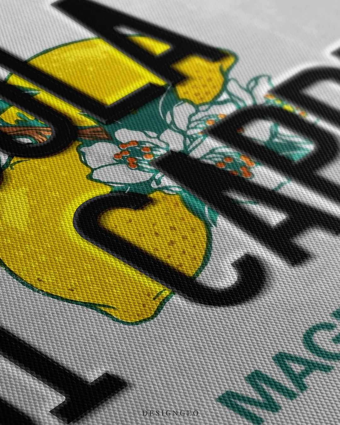 Angled macro view detailing fine woven canvas texture, 3D embossed black lettering of Isola Di Capri, and crisp print detail on the yellow lemon design