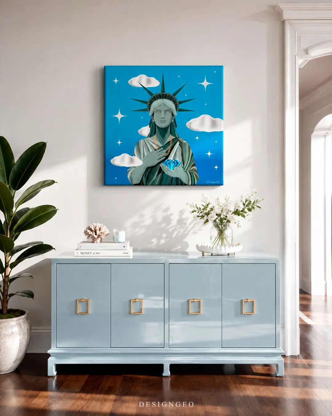 Modern luxury living room setup displaying a square blue canvas print of the Statue of Liberty holding a large glowing blue diamond above a light blue credenza