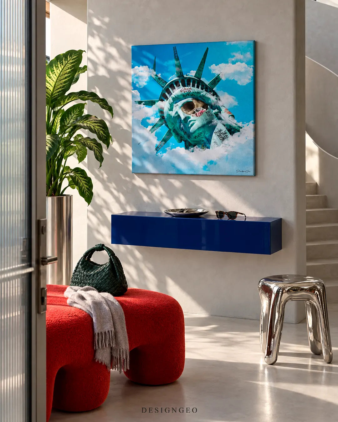 Modern luxury entryway displaying a square canvas print of a surreal Statue of Liberty head with graffiti tags floating among clouds against a bright blue sky
