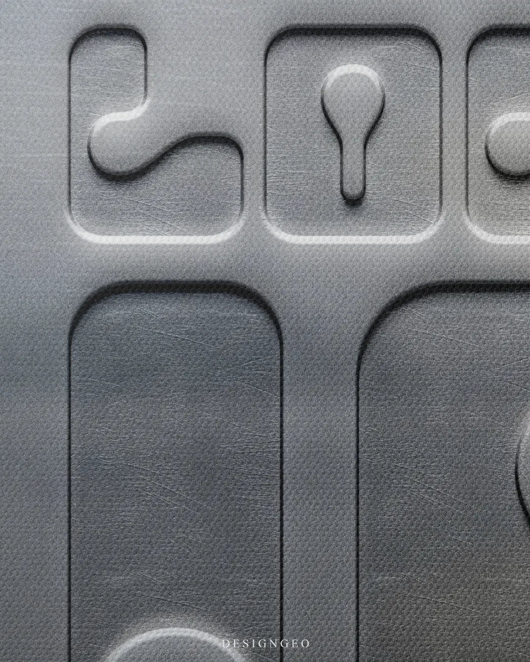 Close-up macro detail shot showing the 3D embossed effect on metallic textured canvas displaying the top letters of the LOCK IN design