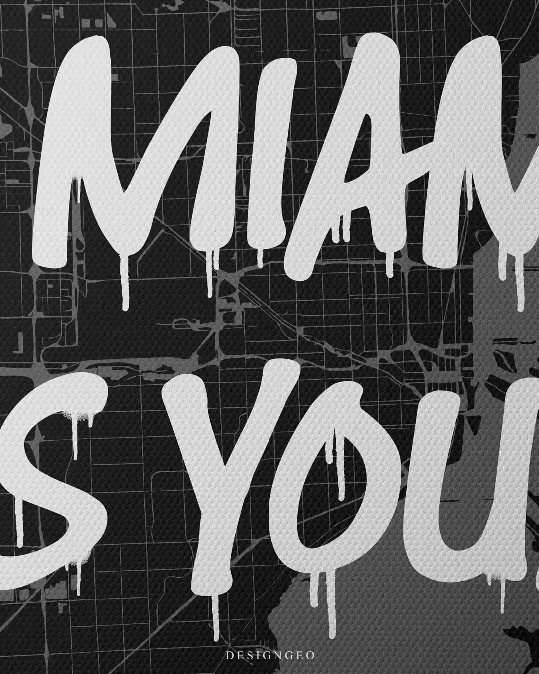 Detailed view of the motivational phrase "Miami is Yours" in street-art style, layered over a minimalist black and grey cartographic map of Miami's urban layout