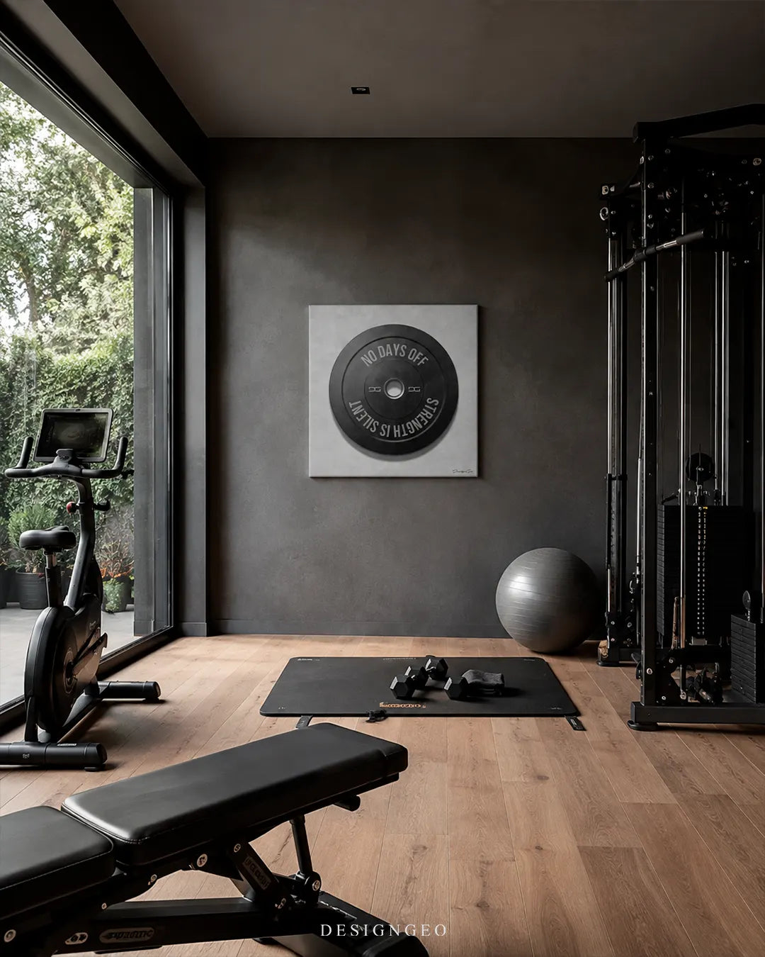 Square No Days Off weight plate canvas wall art mounted on a dark gray concrete wall in a luxury home gym above a workout mat, dumbbells, stationary bike, and cable machine