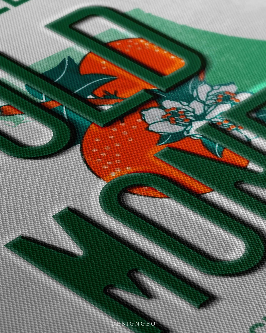 Angled close-up detail shot highlighting the 3D green embossed OLD MONEY letters, vibrant orange fruit graphics, soft shadow drop, and fine woven canvas texture