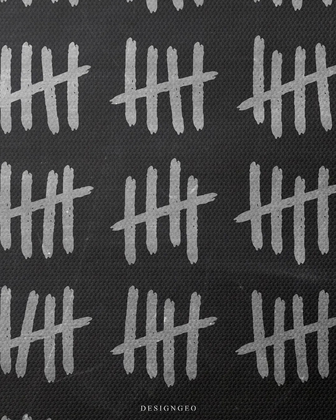 Medium shot showing rows of handwritten white chalk tally marks drawn on a textured black chalkboard background