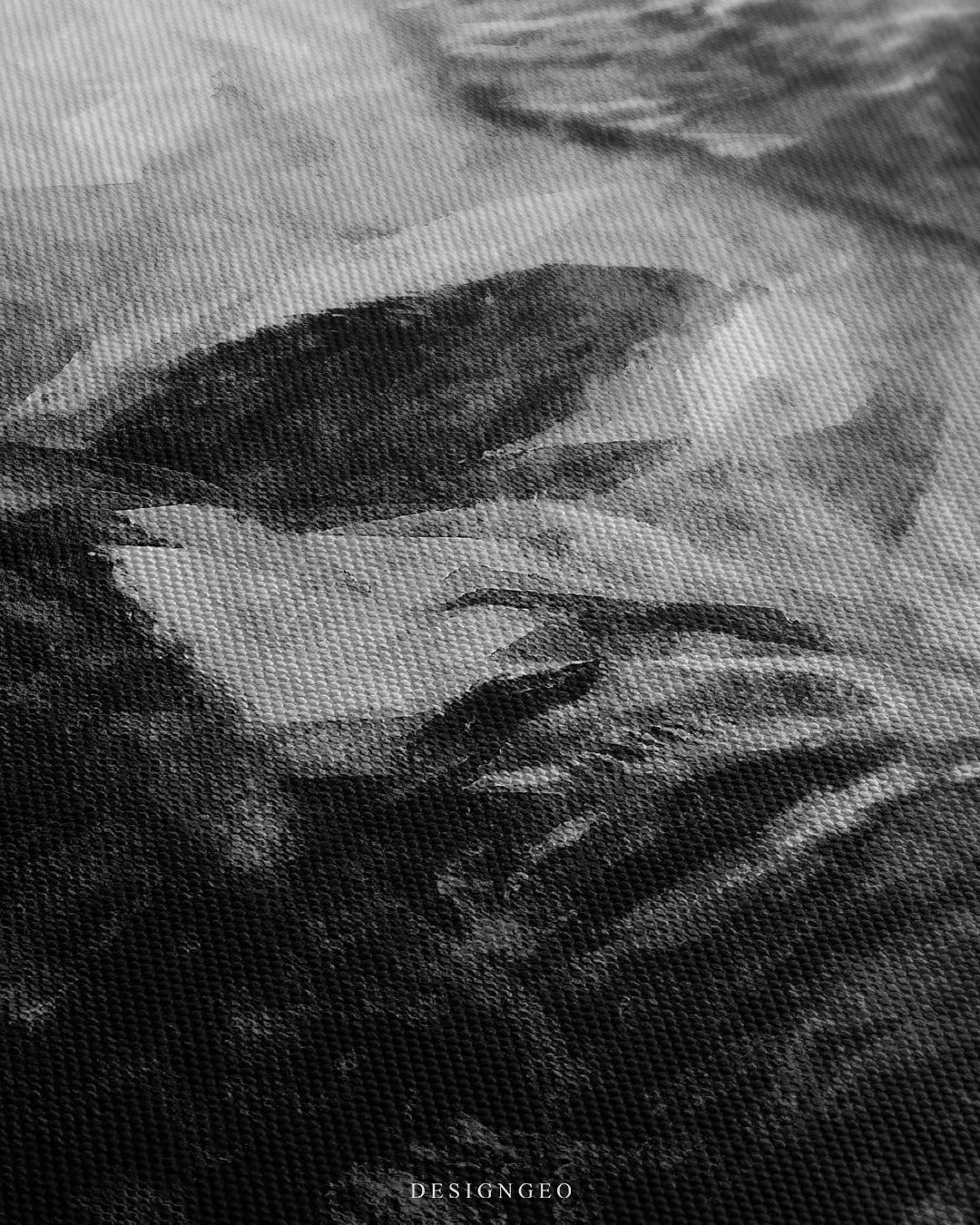 Angled close up view of black and white canvas art highlighting the textured cotton weave and painted brushstroke details