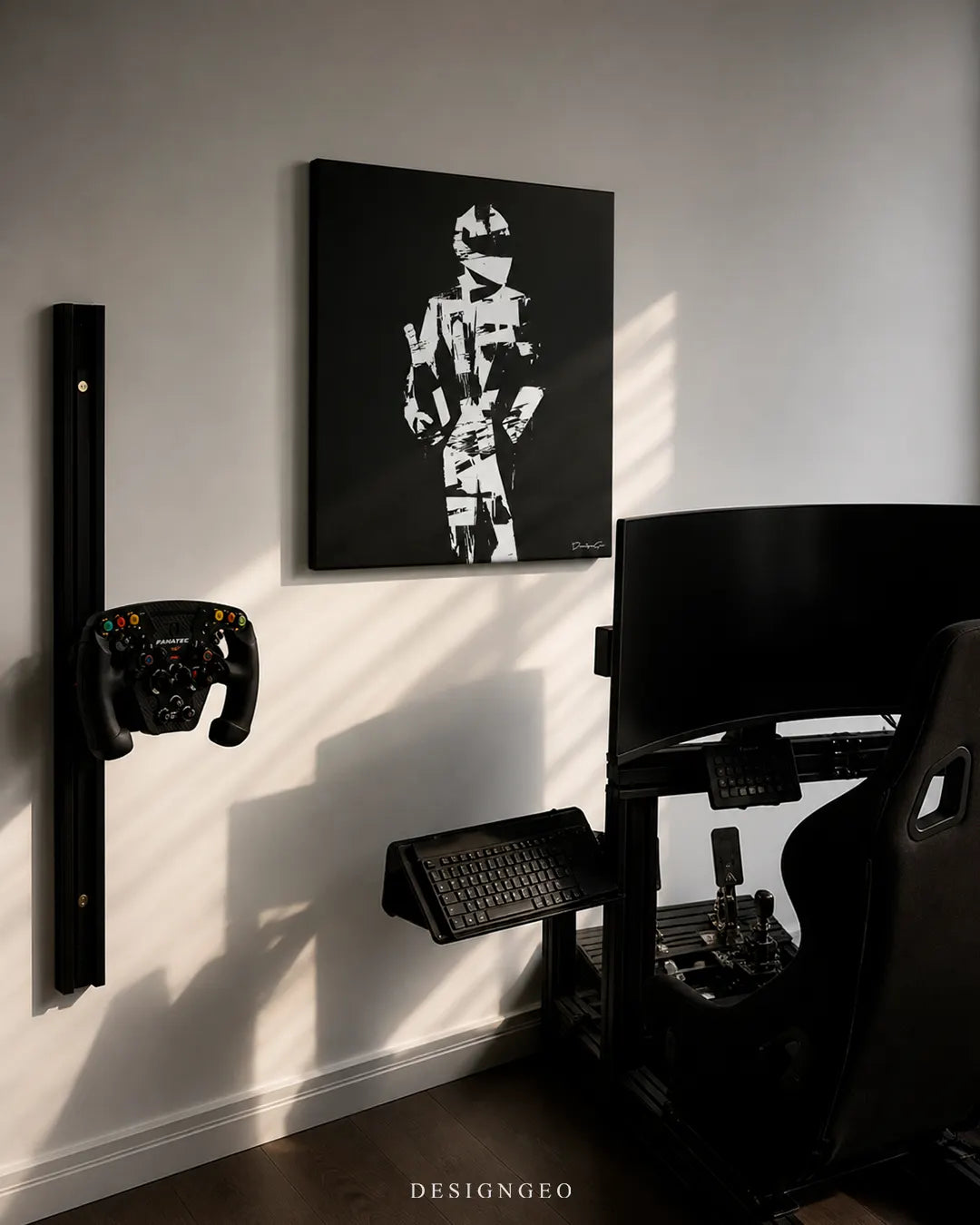 Square black minimalist racing driver canvas print mounted on a white wall above a professional sim racing rig setup with a bucket seat, curved monitor, keyboard tray, and wall-mounted Fanatec steering wheel