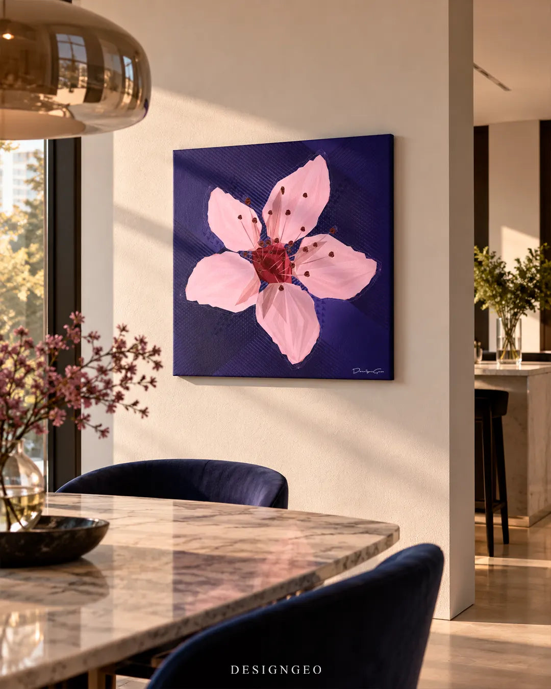 Modern luxury dining room featuring a square canvas print of a single pink cherry blossom flower mounted on a beige wall above a marble table with navy velvet chairs
