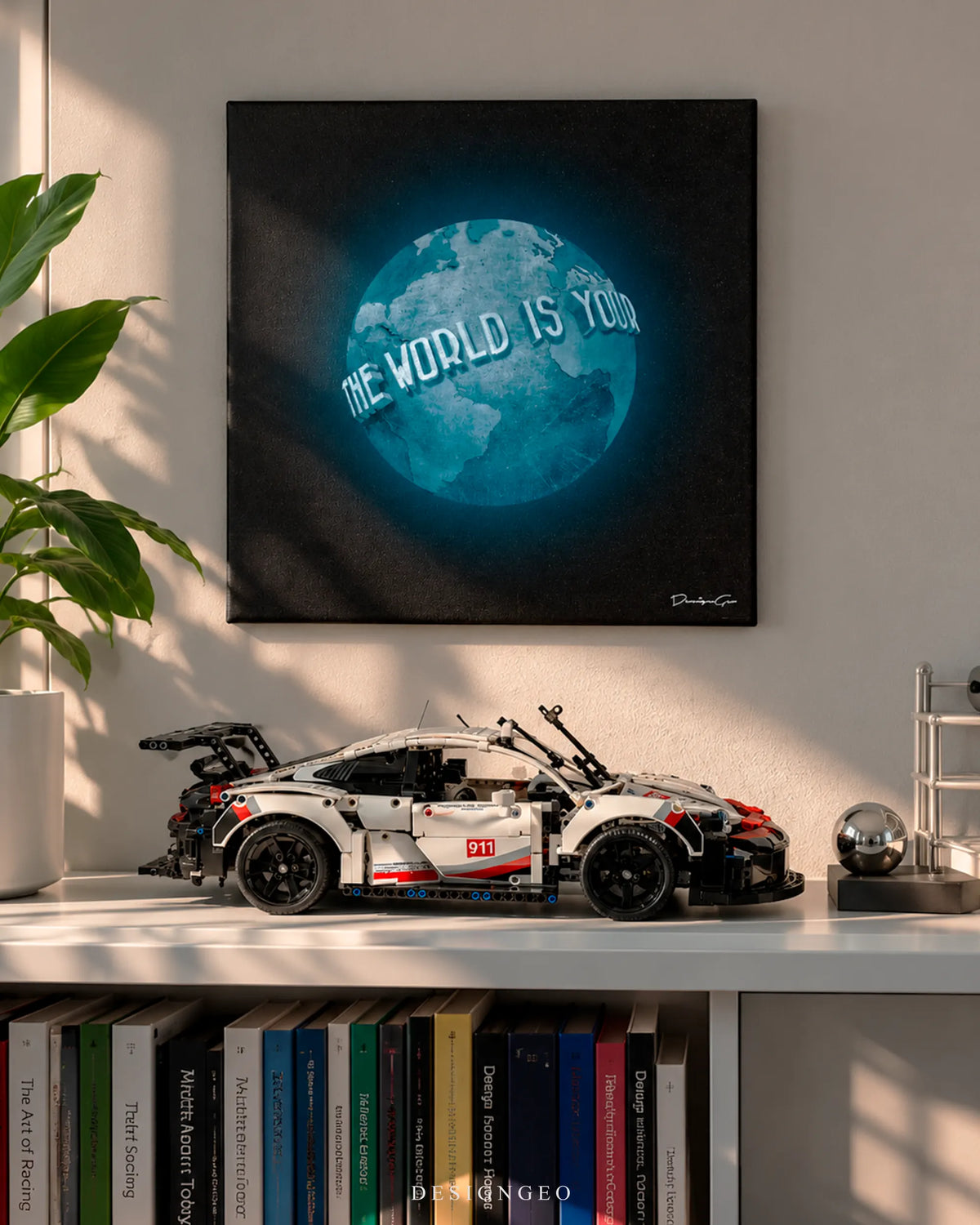 The World Is Yours glowing globe square canvas wall art mounted on light wall above bookshelf with sports car model 0.75 inch thin wrap