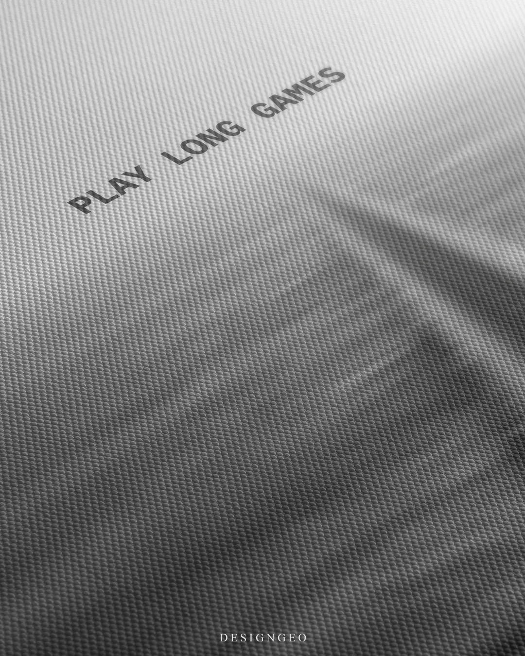 Angled detailed macro texture of fine woven white canvas print showing long straight road perspective and Play Long Games quote