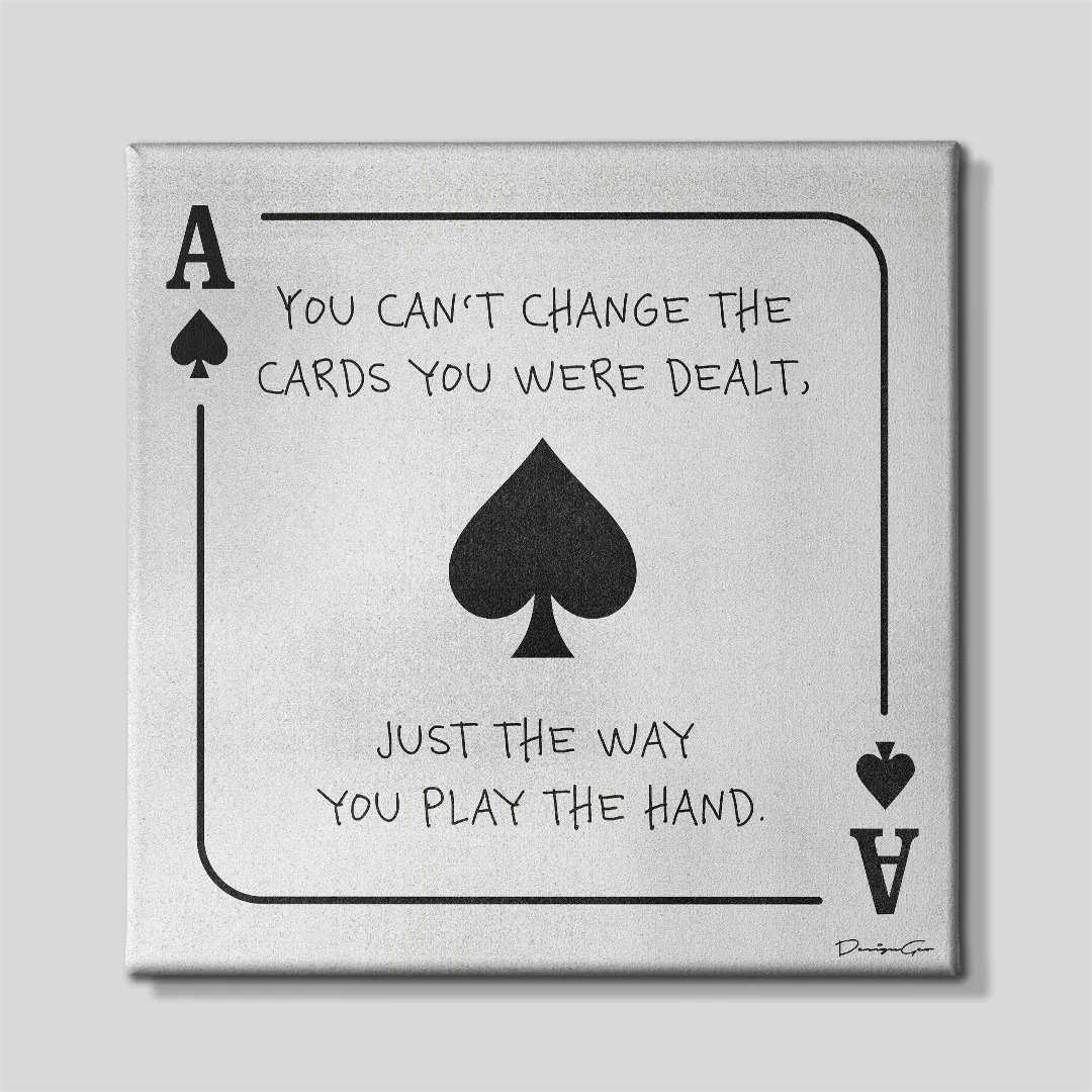 Front view of a square light gray canvas print styled as an Ace of Spades playing card with black handwritten text reading You Can't Change The Cards You Were Dealt, Just The Way You Play The Hand