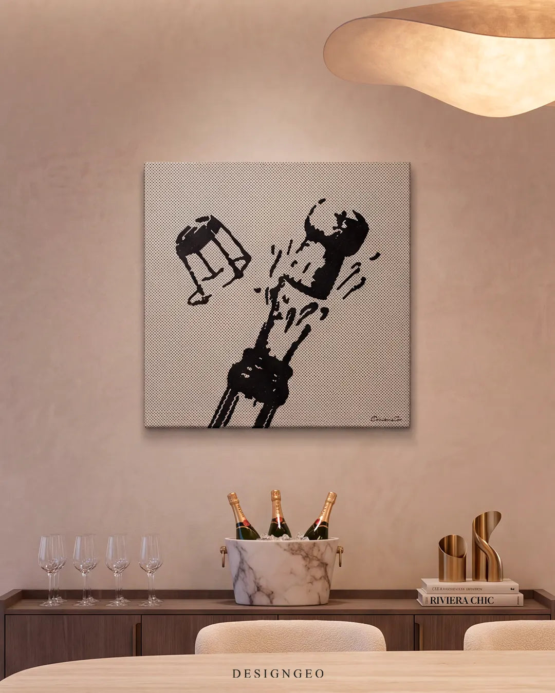Modern luxury dining room interior with warm ambient lighting, displaying the square pop art champagne canvas mounted above a sideboard with an ice bucket and wine glasses