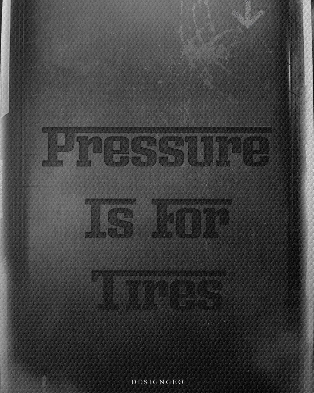 Medium shot close-up highlighting black bold stencil typography reading Pressure Is For Tires printed directly onto a rubber slick racing tire tread