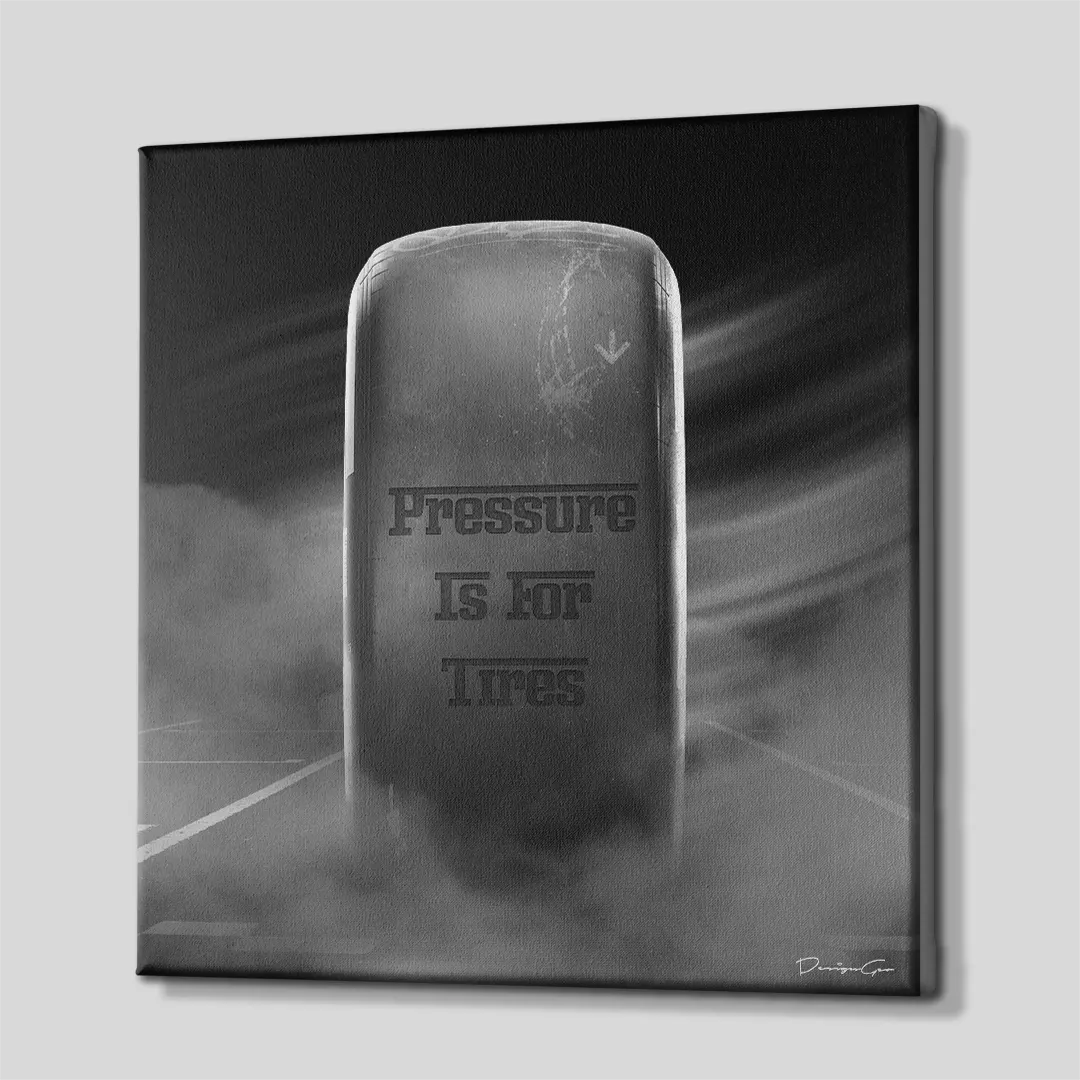Three-quarter side angle of the Pressure Is For Tires racing canvas wall art showing gallery-wrapped dark gray printed edges mounted on a sturdy wooden stretcher frame