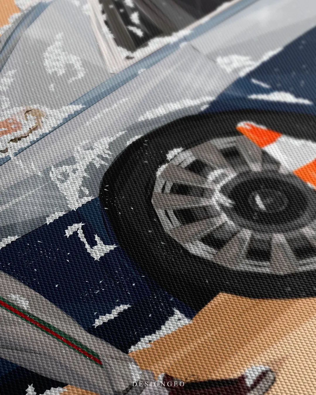 Angled extreme macro view highlighting the woven canvas surface texture, silver luxury car multi-spoke wheel, traffic cone, and white soap foam