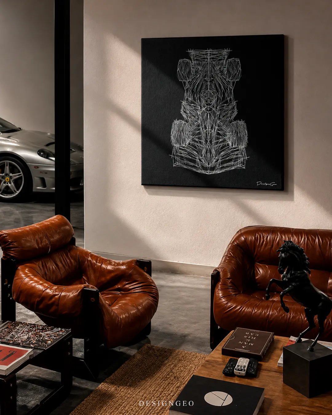 Square white racing car wireframe canvas print mounted on a beige wall in a luxury garage lounge above brown leather armchairs, a wooden coffee table with a black horse statue, and a silver sports car in the background