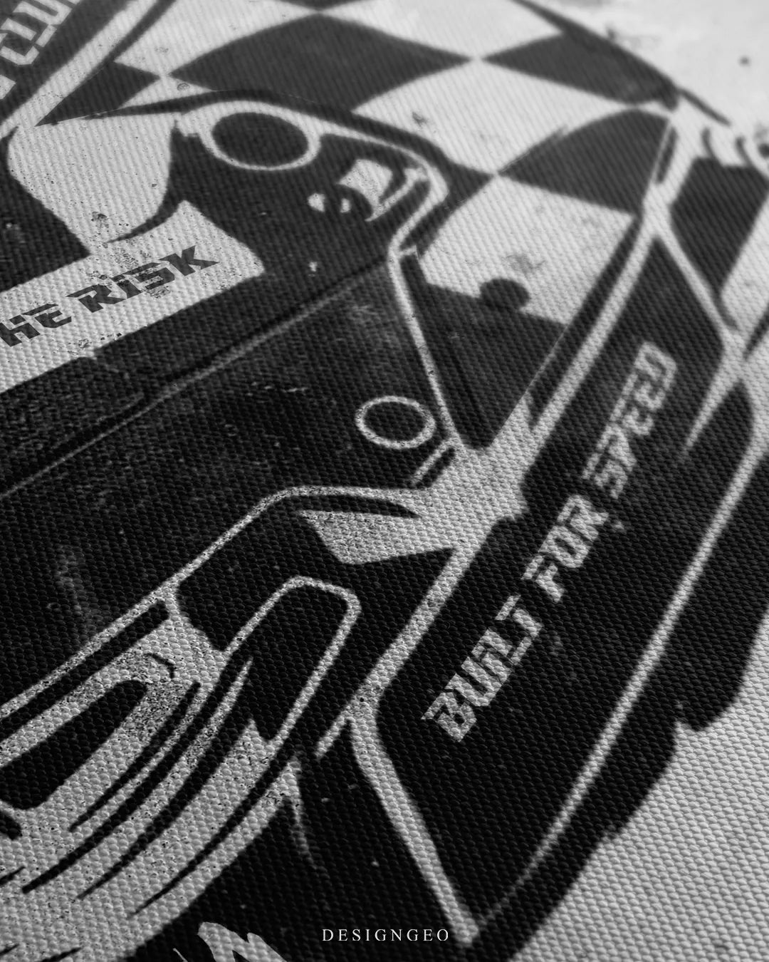Close-up shot of the racing helmet canvas art, highlighting the fine woven canvas texture, sharp black ink print, and the phrase "Built for Speed"